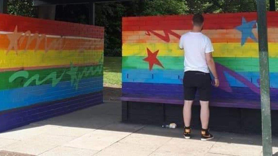 Artist repairing mural