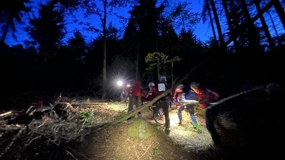 Patient carried through forest