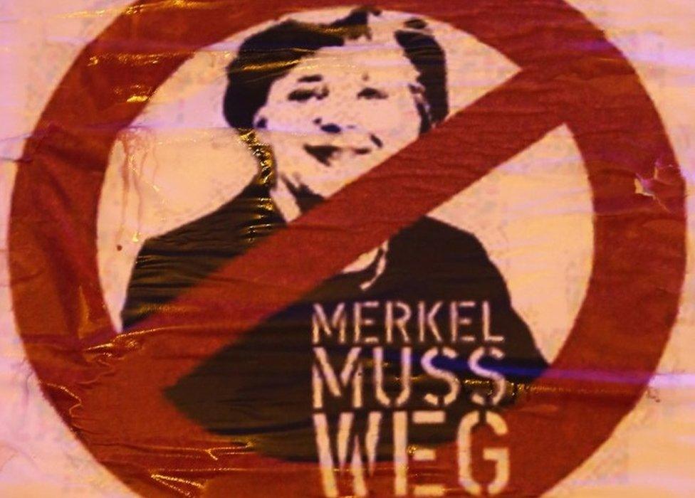 A sign that reads "Merkel must go" hangs froma truck during a rally by supporters of the AfD political party protesting against German Chancellor Angela Merkel"s liberal policy towards taking in migrants and refugees on October 14, 2015