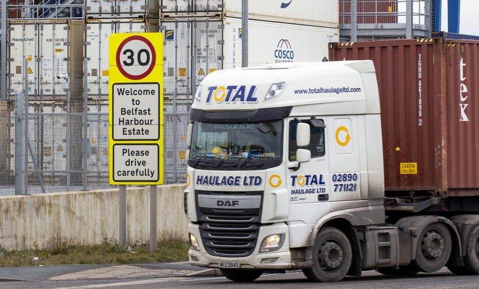 A lorry hauls a shipping container leaves Belfast Harbour