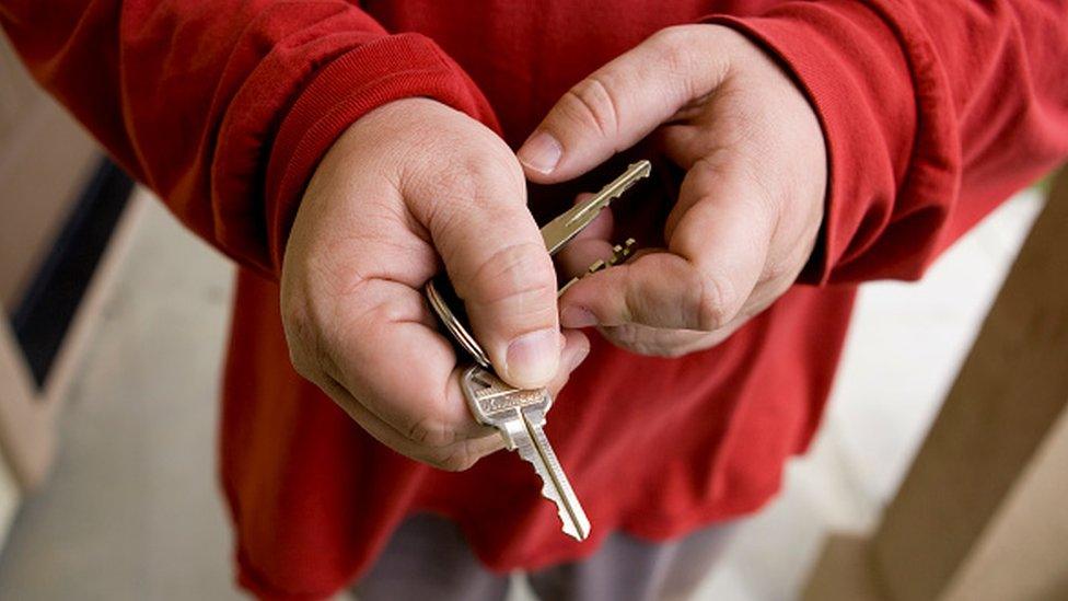 A man holding house keys