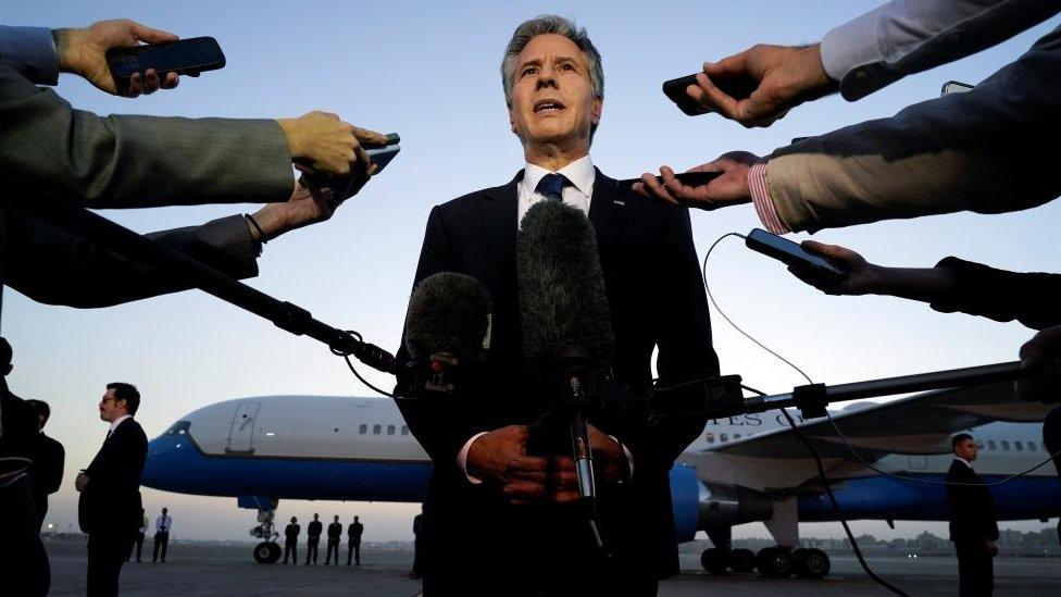 U.S. Secretary of State Antony Blinken speaks to members of the media on a runway before leaving Cairo, Egypt