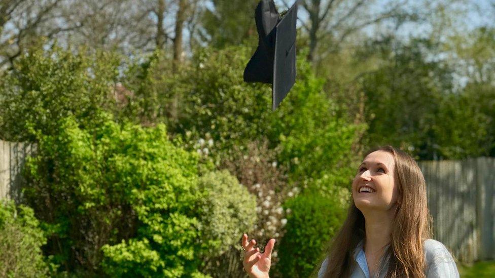 Molly Dineen throwing her mortarboard in the air