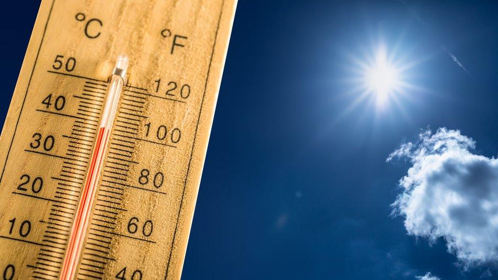 Thermometer against a blue sky