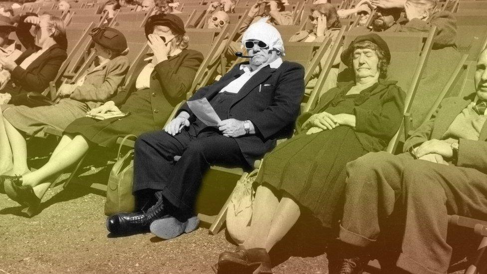 Photo from 1950s London of people sat in deckchairs