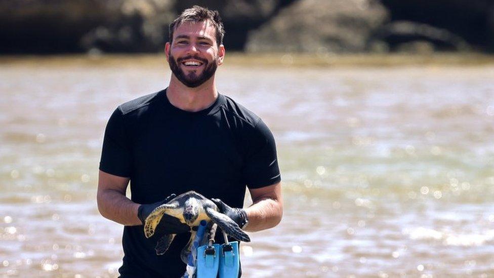 a man carrying a turtle