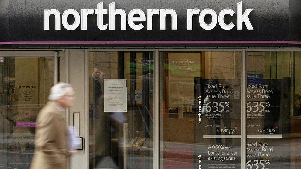 Man walks past a Northern Rock branch