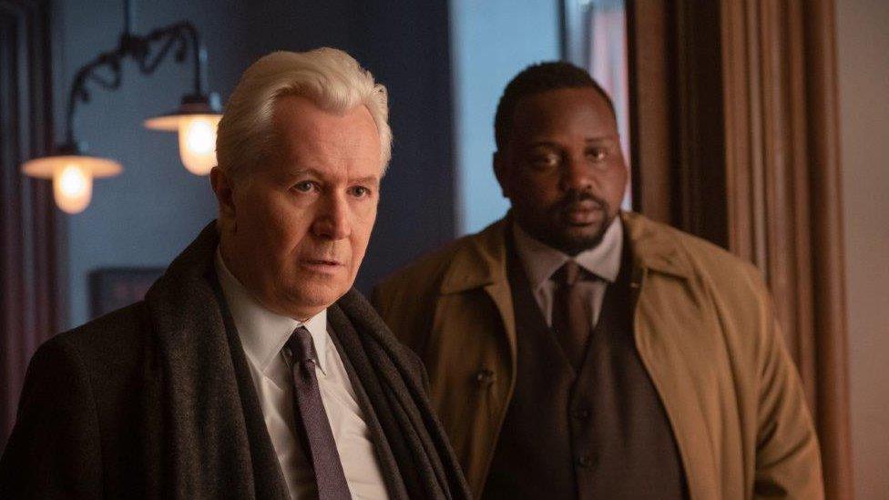 Gary Oldman as Alistair Russell and Brian Tyree Henry as Detective Little