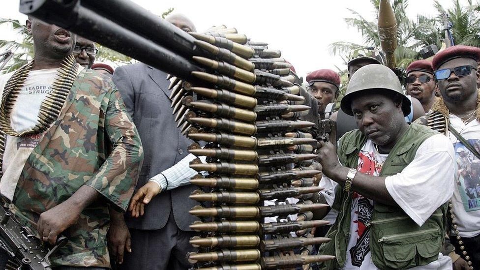 A militant examines a machine gun