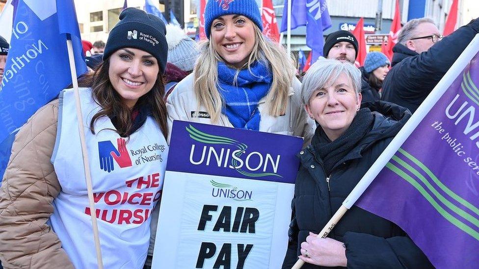 Female workers on strike, at Belfast rally