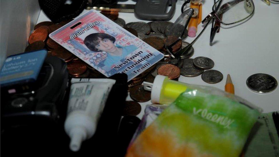 A mess of items contain a technology id card for Adam Lanza