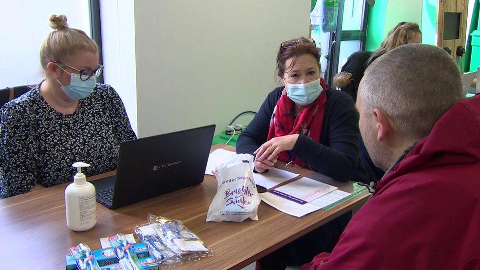 Health professaionls helping a homeless man