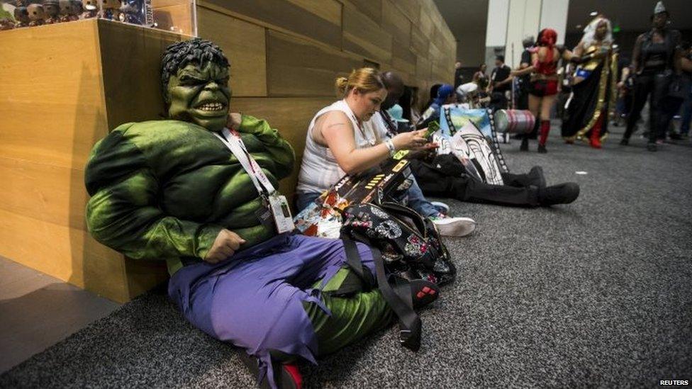 A cosplay enthusiast dressed like the character of The Hulk waits during the 2015 Comic-Con International Convention in San Diego, California 10 July 2015