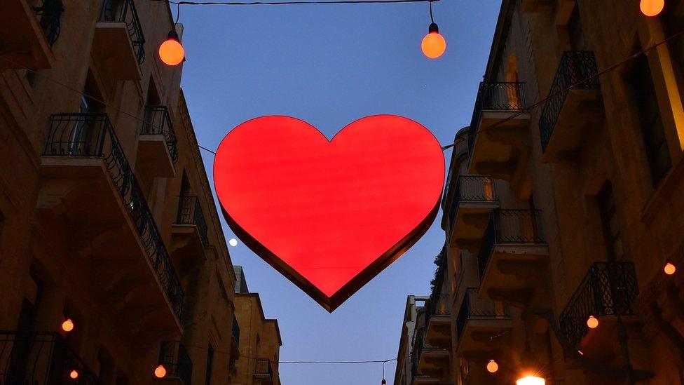 Illuminated signs of Valentine's Day decorate a shopping district in Beirut, Lebanon, 8 February 2017