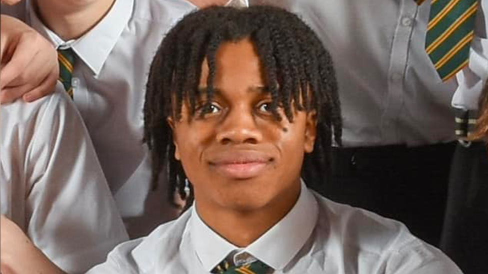 David Ejimofor school photo surrounded by classmates