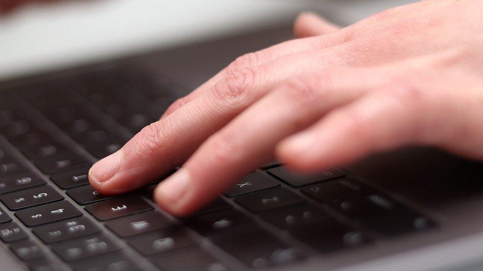 Hand and laptop keyboard