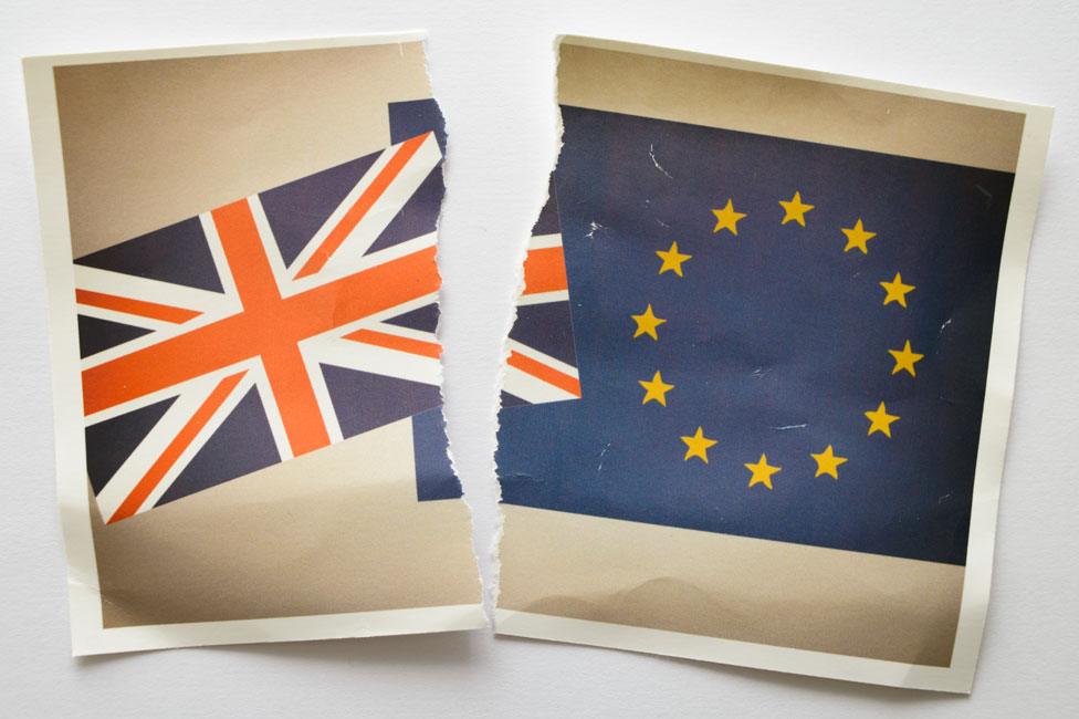 A torn photograph showing the UK and EU flags