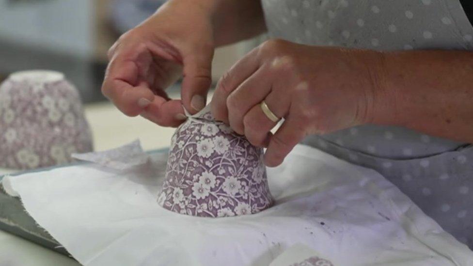 Design being applied to pottery