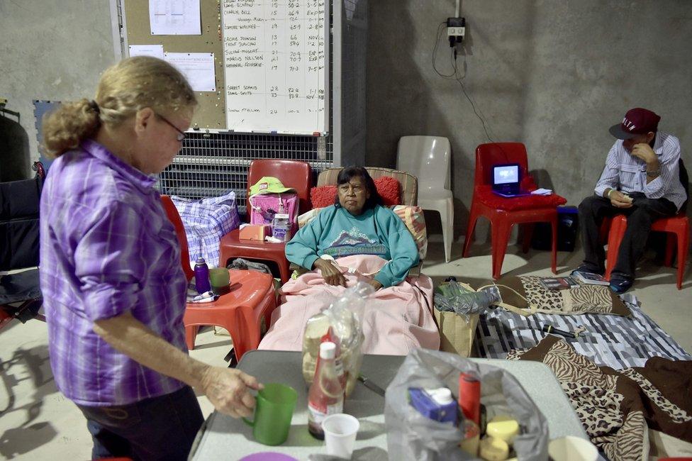 A family relaxes in a temporary cyclone shelter in the town of Ayr in far north Queensland as Cyclone Debbie approaches on 28 March 2017.