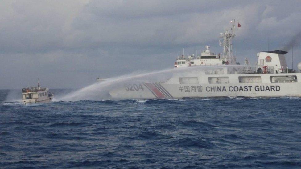 A Chinese Coast Guard ship uses a water cannon against a Filipino resupply vessel heading towards the disputed Second Thomas Shoal, in the South China Sea, on 10 December