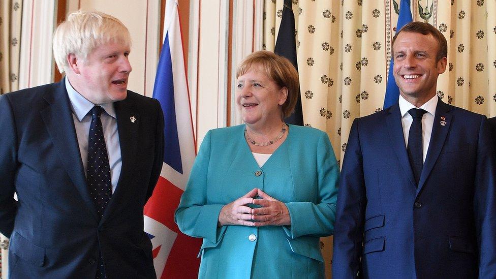 boris-johnson-angela-merkel-and-emmanuel-macron-standing-together