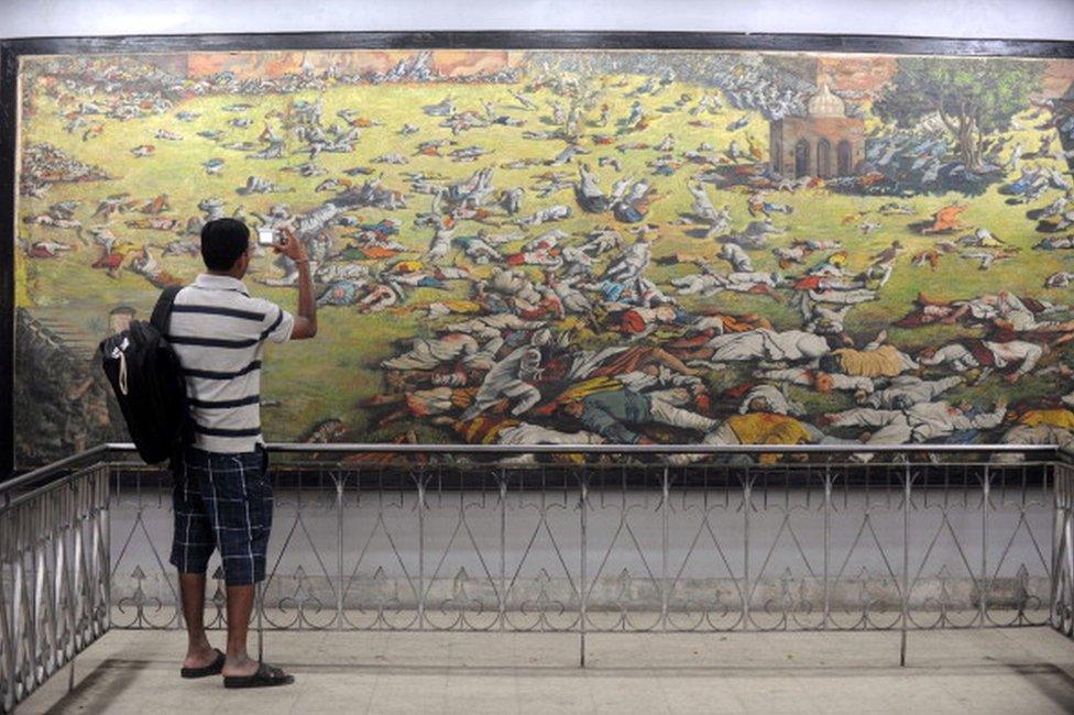 An Indian man takes a photograph of a painting depicting the Jallianwala Bagh massacre in Amritsar on April 12, 2011. The Amritsar massacre, also known as the Jallianwala Bagh Massacre, took place on April 13, 1919 when British Indian Army soldiers on the direct orders of their British officers opened fire on an unarmed gathering killing at least 379 men, women and children, according to official records. AFP PHOTO /NARINDER NANU (Photo credit should read NARINDER NANU/AFP/Getty Images)