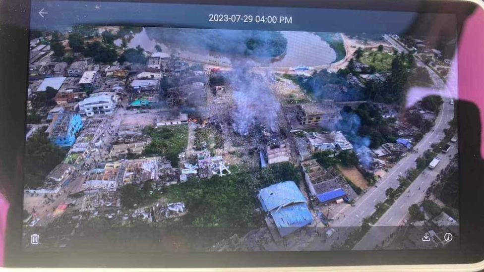 Photograph taken by a drone of smoke rising over the market and several destroyed buildings