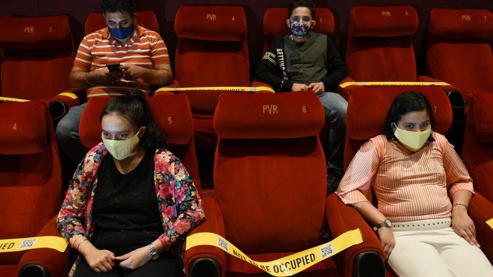 Family members of frontline Covid-19 workers watch a movie in Delhi on 15 Oct 2020