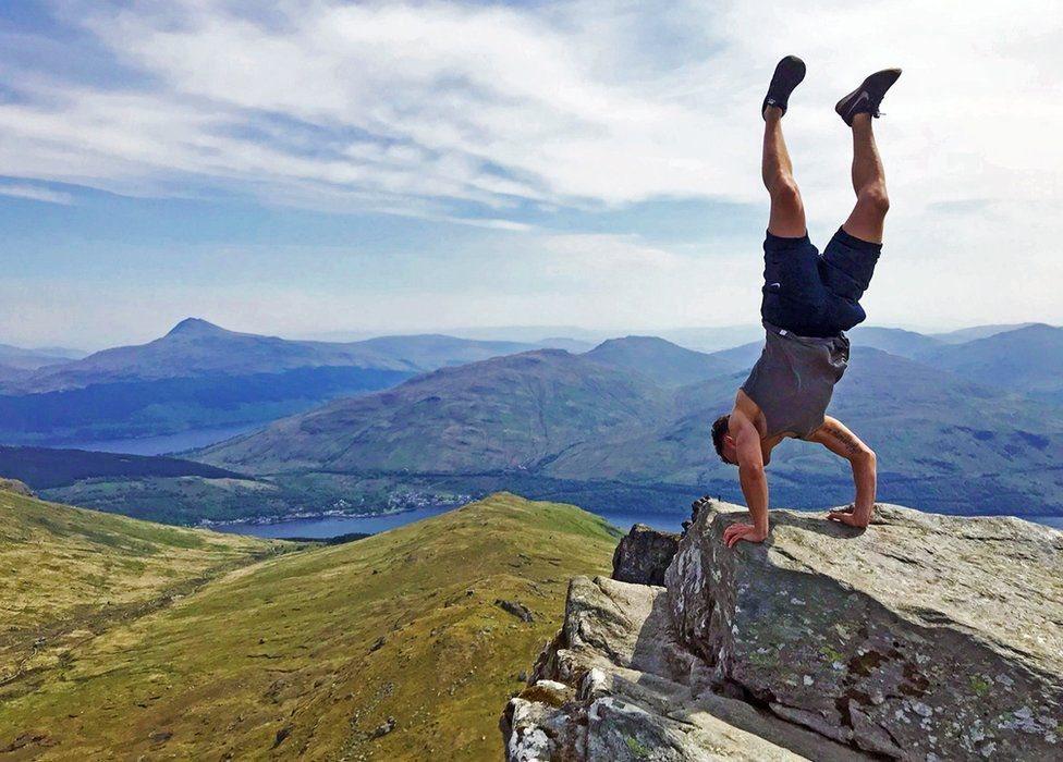 John Trippick admiring the upside down view from The Cobbler after climbing with friends on a gloriously sunny Sunday.