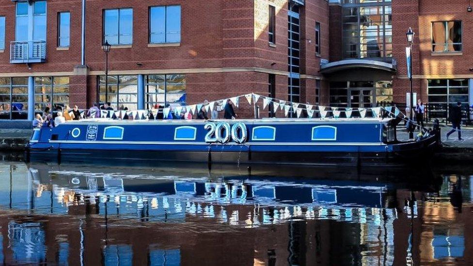 Canal boat with '200' balloon