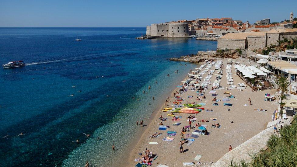 People enjoying time on a beach in Dubrovnik, Croatia