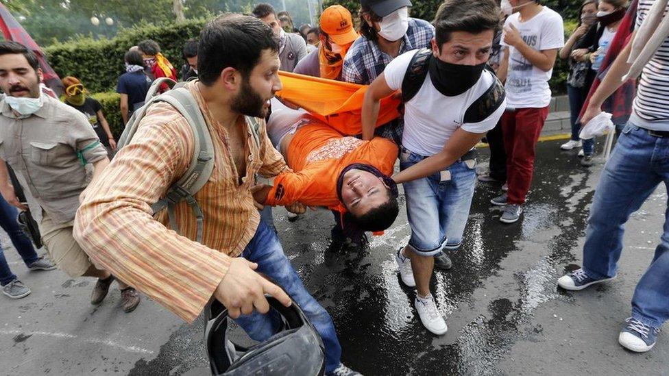 Protesters carry an injured man in central Ankara, 2 June.