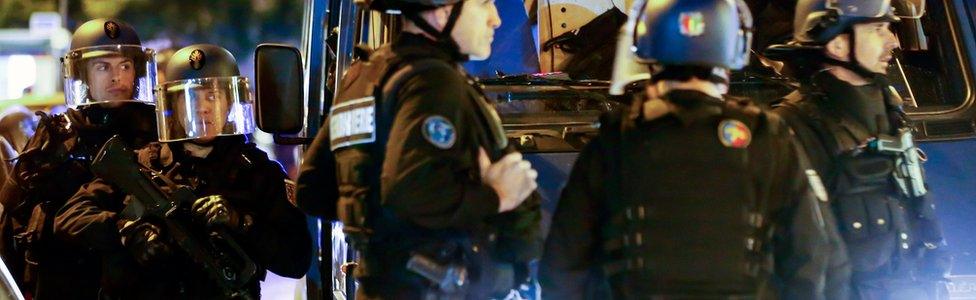 French Police officers react after a shooting in which one police officer was killed on 20 April