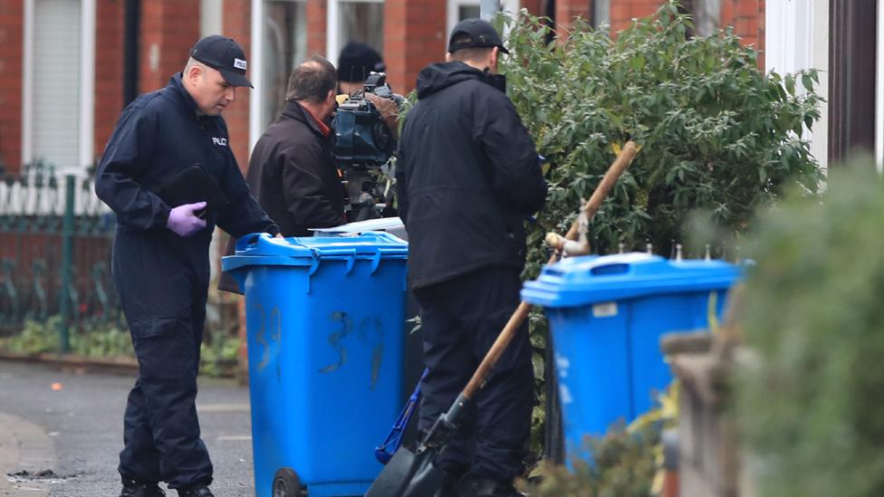 Police searching outside house