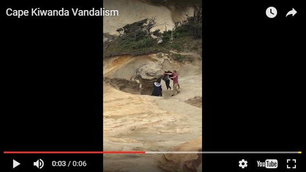 People appearing to pull duckbill rock down