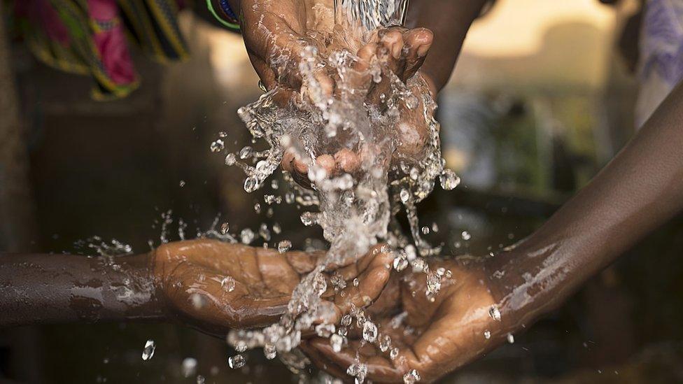 Children in Burkina Faso enjoying clean water provided by a charity