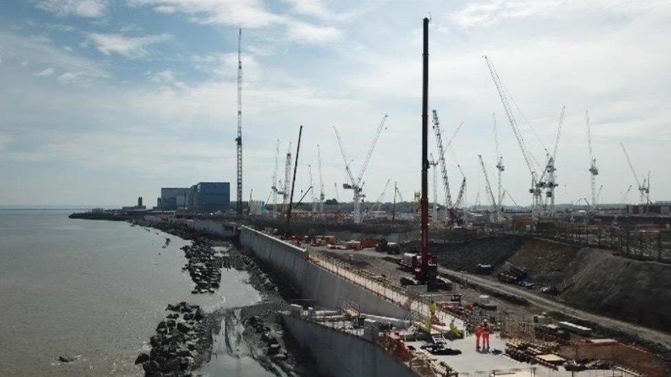 The Hinkley Point C cranes with the Hinkley Point A buildings in the background