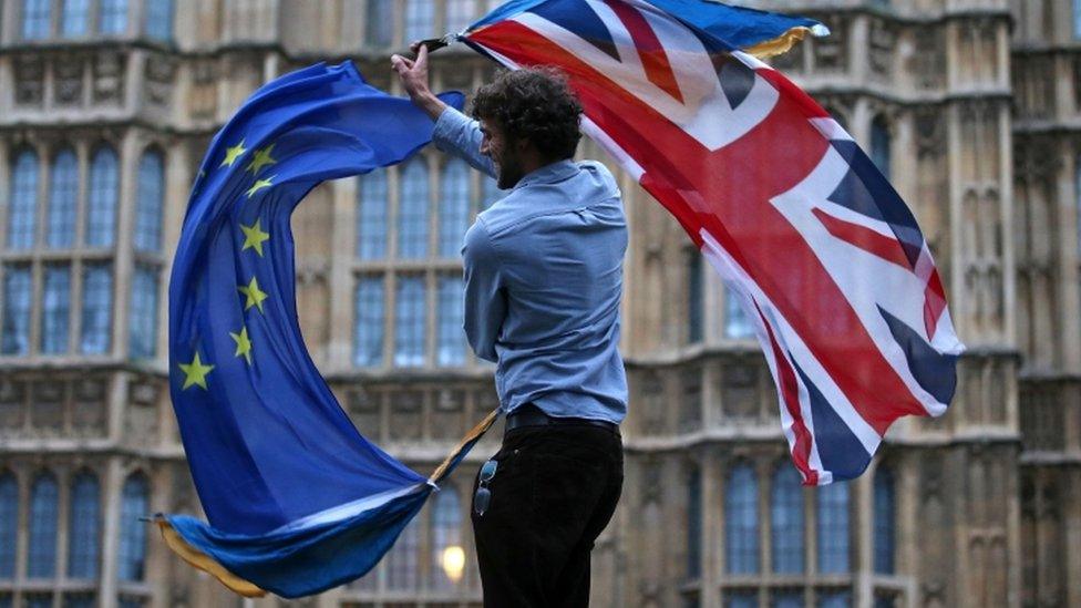 Man waving a union flag and an EU flag