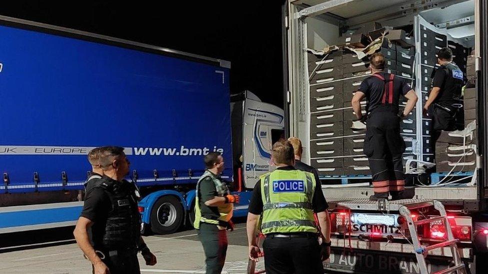 Police and emergency workers with a lorry