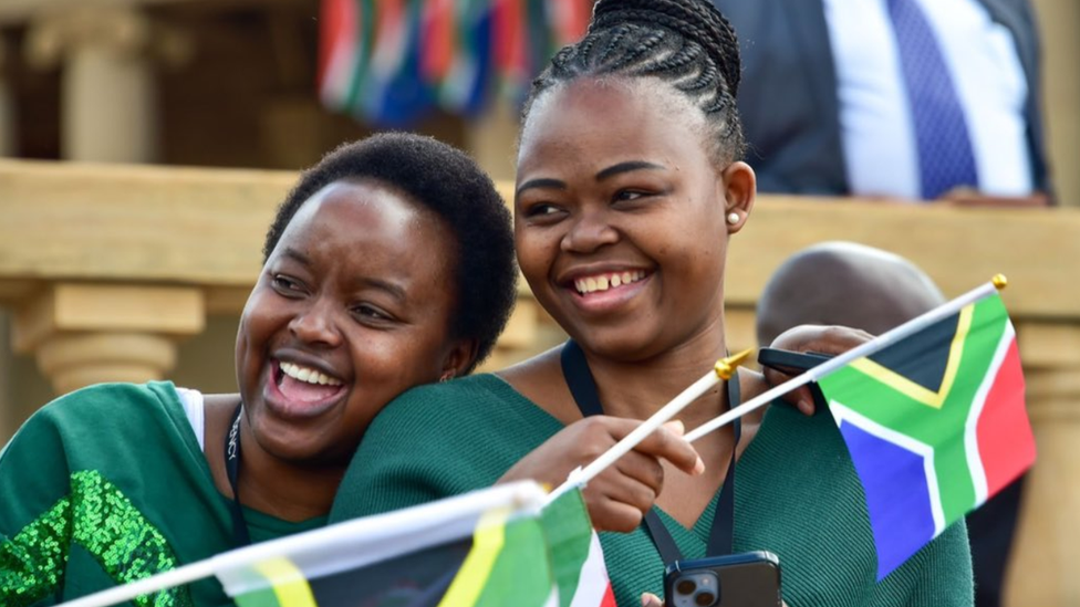 Two supporters holding flags