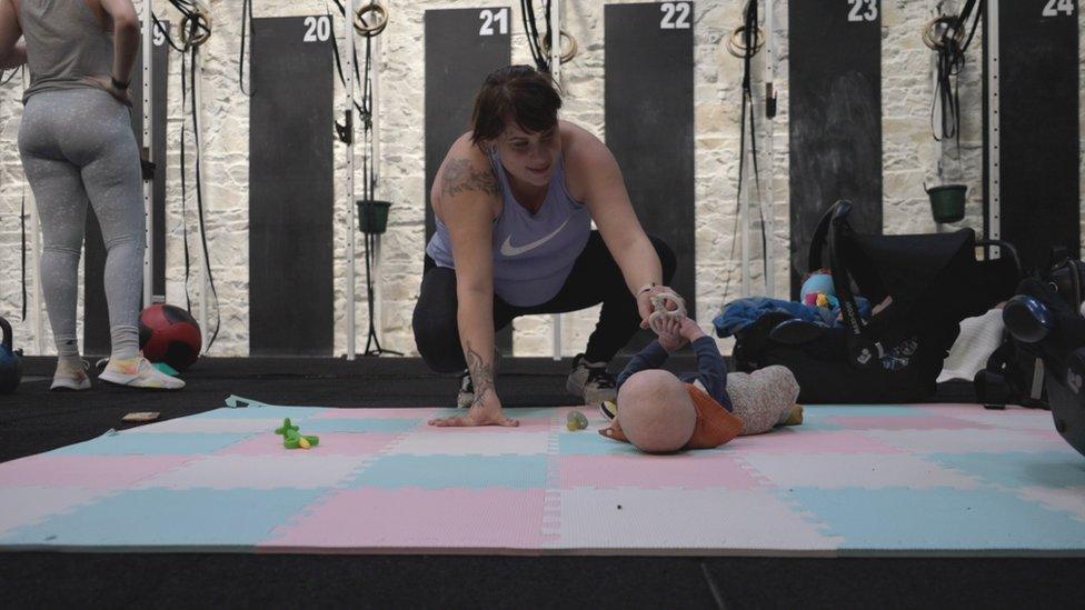 Mother with baby on mat