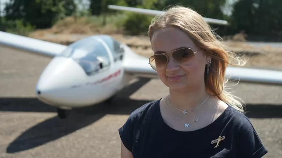 Glider pilot in front of her craft