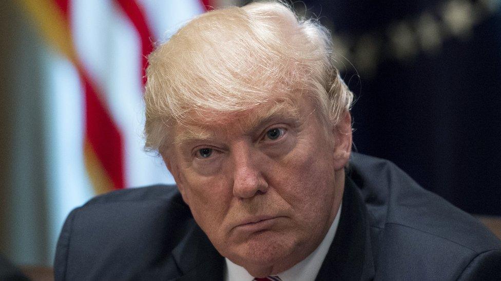 President Donald Trump listens as he meets with immigration crime victims to urge passage of House legislation to save American lives, in the Cabinet Room at the White House on June 28, 2017 i