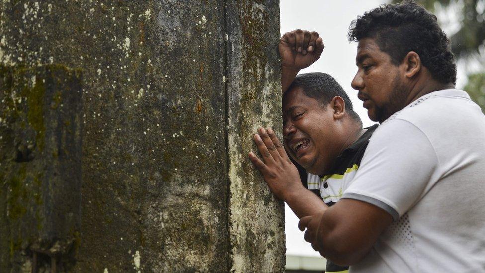 Relatives and friends of Deisy Rosero, 26, mourn during her funeral at a cemetery in Mocoa, Putumayo department, southern Colombia