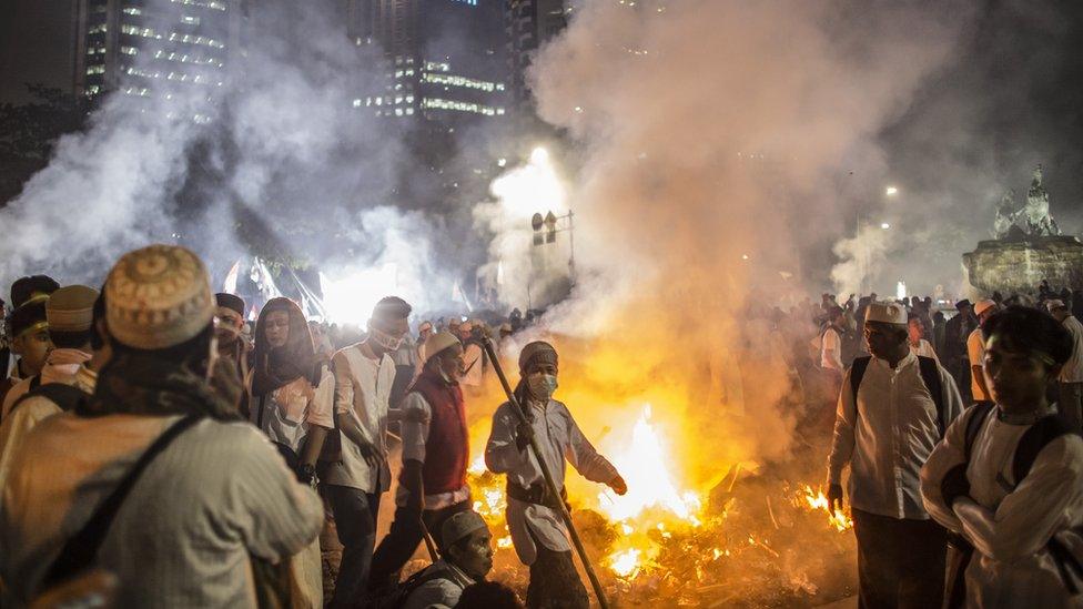 Demonstrators march in Jakarta, Indonesia, after a day of protest, 4 November 2016