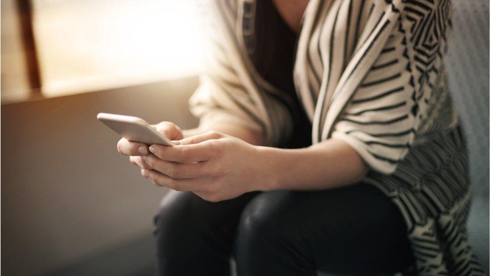 Woman holding a phone