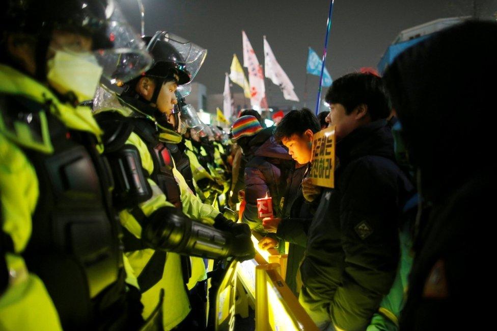 People attend a protest calling for Park Geun-hye to step down on a road leading to the Presidential Blue House in Central Seoul, South Korea, on 26 November, 2016