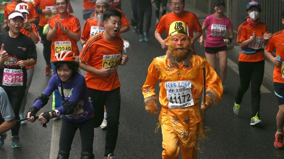 A participant dressed as Monkey God, takes part in the Beijing Marathon