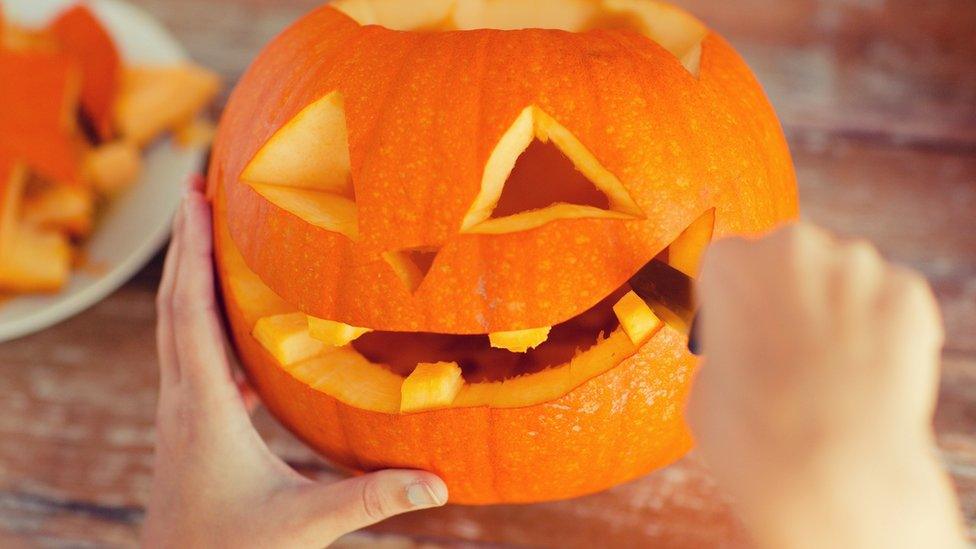 Pumpkin being carved.