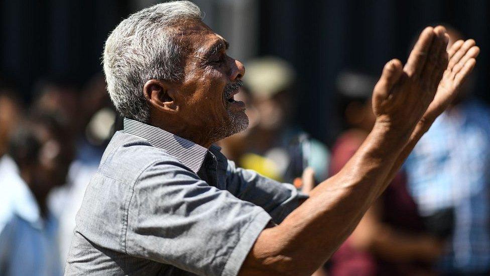 A man cries as he prays outside the St Anthony's Shrine in Colombo on April 22, 2019